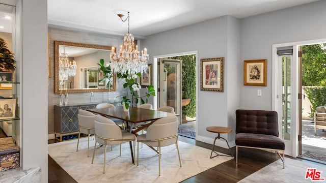 dining room with a notable chandelier and light hardwood / wood-style flooring