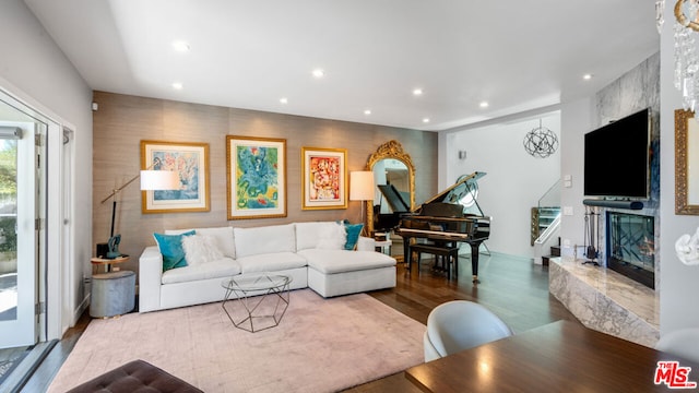 living room featuring a premium fireplace and hardwood / wood-style floors