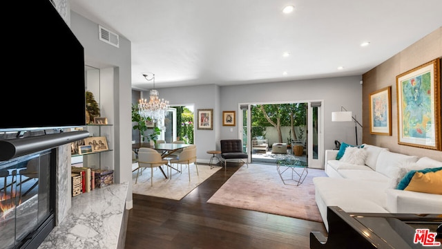 living room featuring dark hardwood / wood-style floors and a chandelier