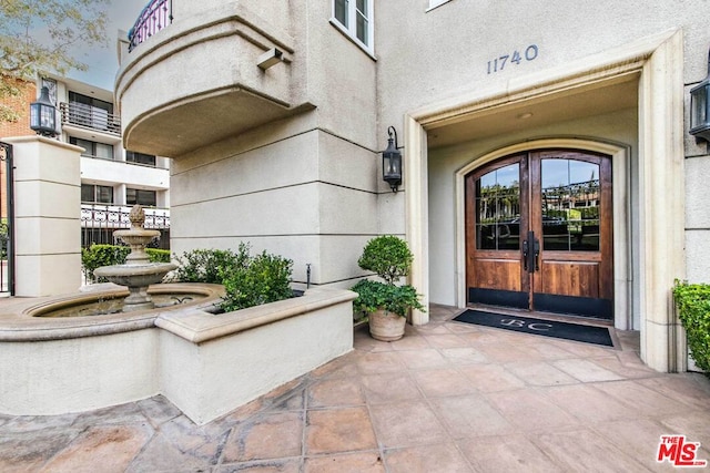 entrance to property featuring french doors