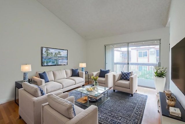 living room with hardwood / wood-style flooring and high vaulted ceiling