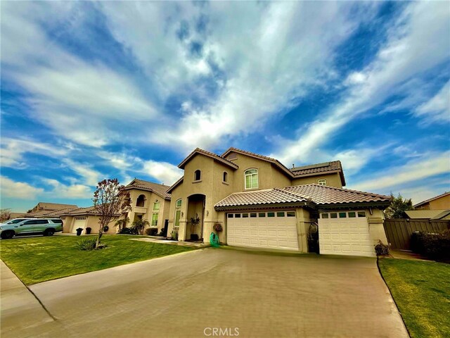 mediterranean / spanish-style house with a front yard