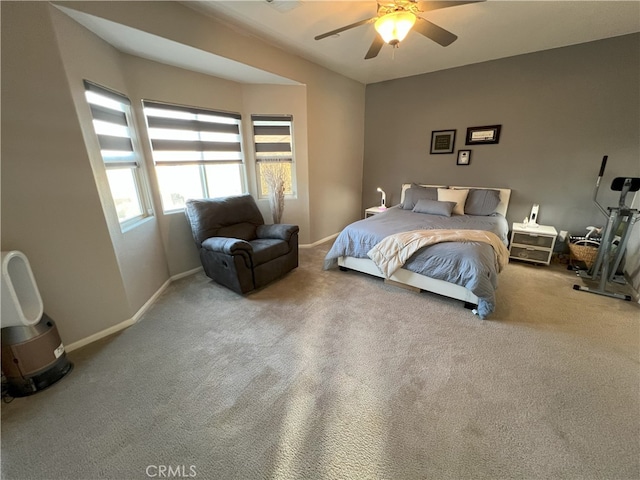 bedroom featuring light carpet, ceiling fan, and baseboards