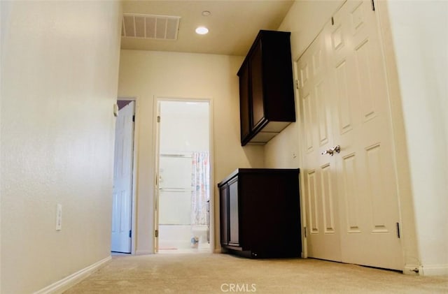 unfurnished bedroom featuring baseboards, visible vents, connected bathroom, light colored carpet, and recessed lighting