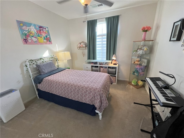 bedroom featuring light carpet, baseboards, visible vents, and a ceiling fan