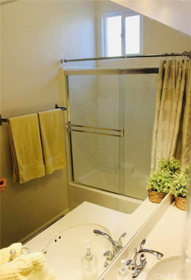 full bathroom featuring shower / bath combination with curtain, vaulted ceiling, and a sink