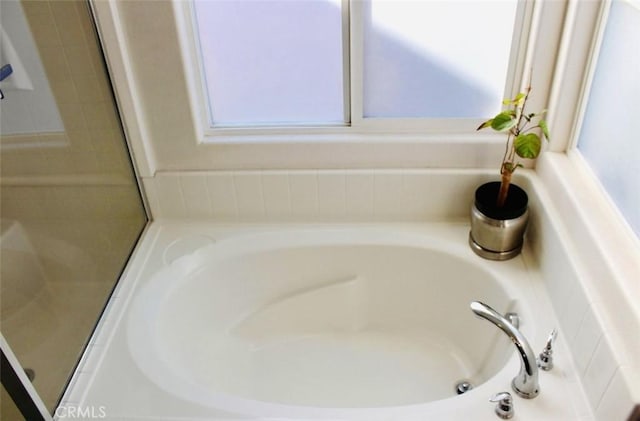 bathroom featuring a tub to relax in