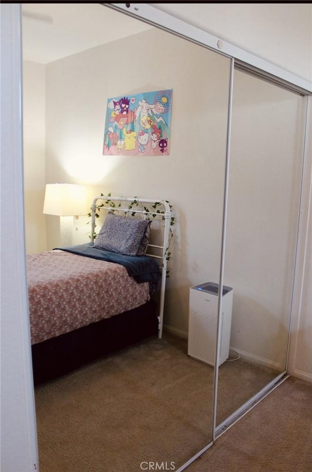 carpeted bedroom with a closet