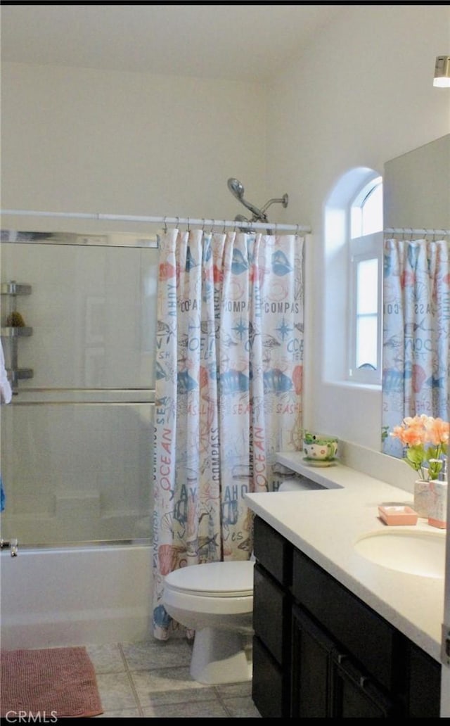 bathroom featuring toilet, shower / tub combo, vanity, and tile patterned floors