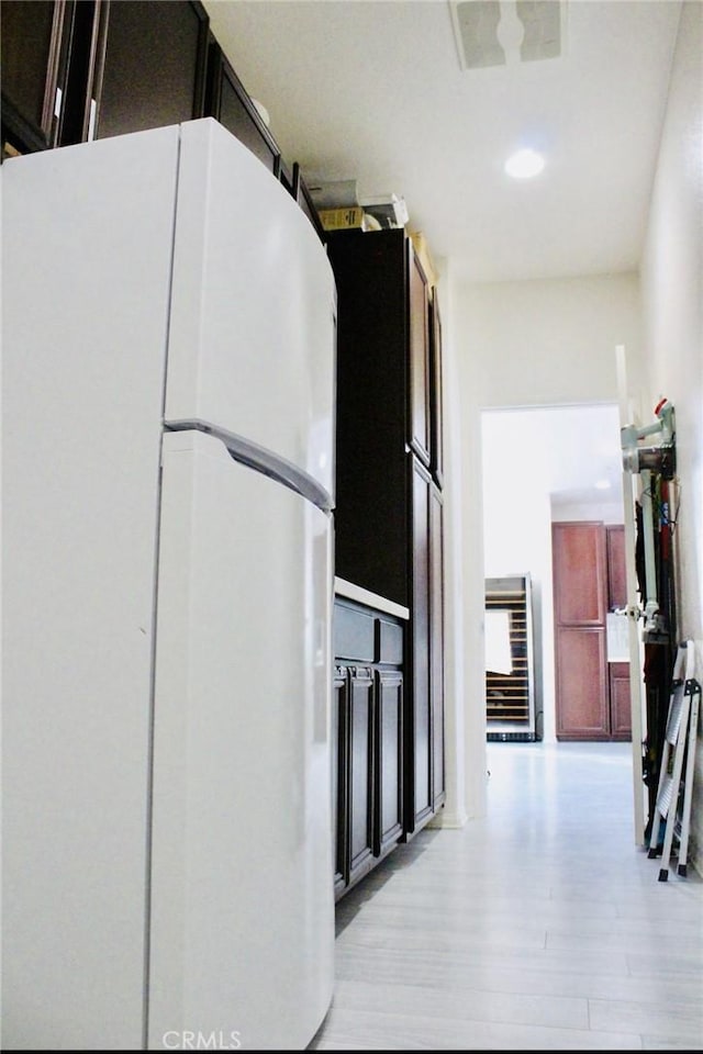 hall featuring beverage cooler, visible vents, and light wood-style flooring