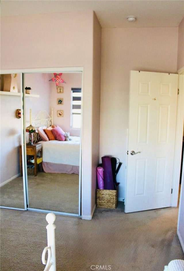 bedroom with carpet and a closet