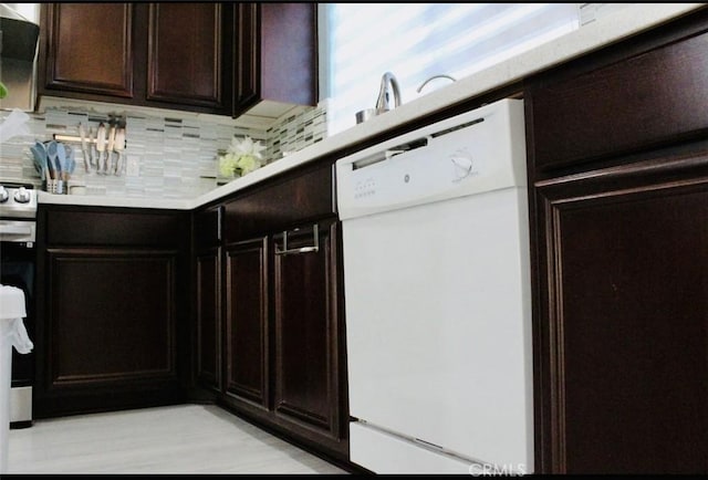 kitchen featuring dishwasher, light countertops, stainless steel electric range oven, and backsplash