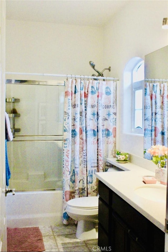 full bath with shower / tub combo, vanity, toilet, and tile patterned floors