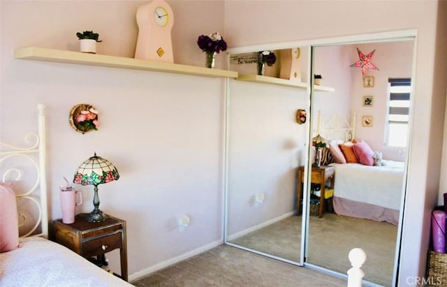 bedroom with a closet, baseboards, and carpet flooring