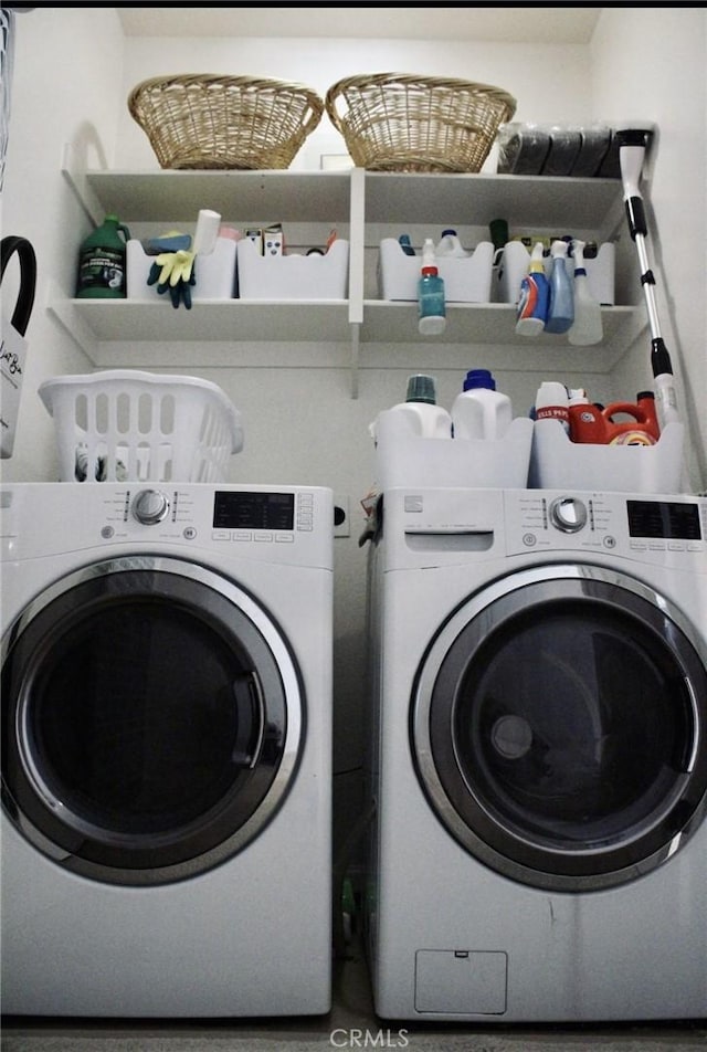 washroom featuring laundry area and separate washer and dryer