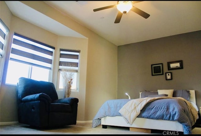 bedroom with ceiling fan and baseboards