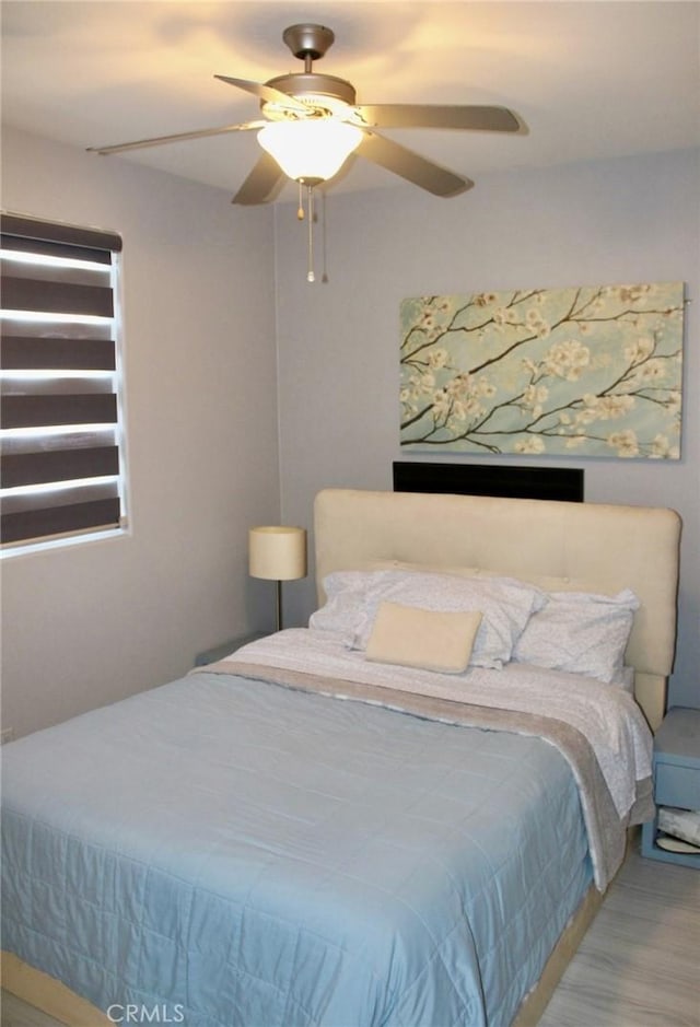 bedroom featuring a ceiling fan and wood finished floors