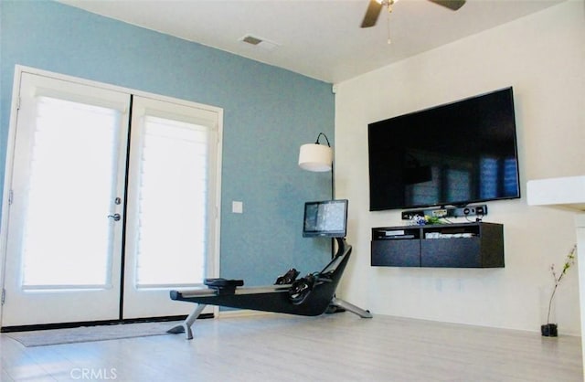 workout area with visible vents, french doors, a ceiling fan, and wood finished floors