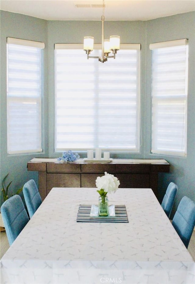 dining space with a chandelier