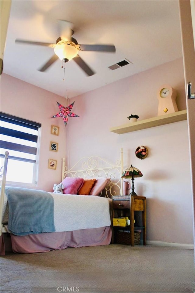 bedroom with baseboards, ceiling fan, visible vents, and carpet flooring