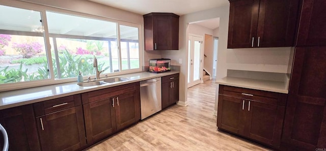 kitchen with a sink, light wood-type flooring, dishwasher, and light countertops