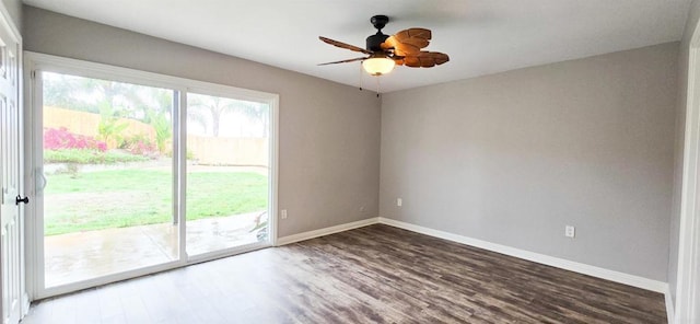 empty room featuring baseboards, wood finished floors, and a ceiling fan