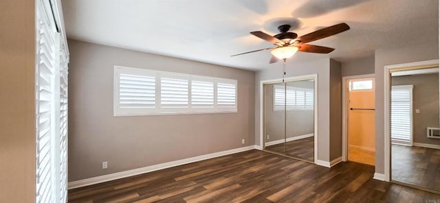 unfurnished bedroom featuring baseboards and dark wood finished floors