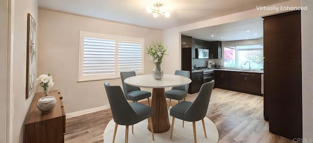 dining room featuring light wood-style floors and baseboards