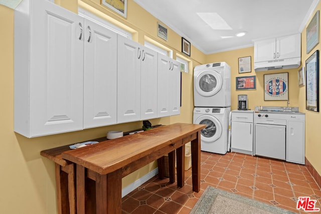 clothes washing area featuring stacked washer / dryer, ornamental molding, and light tile patterned floors