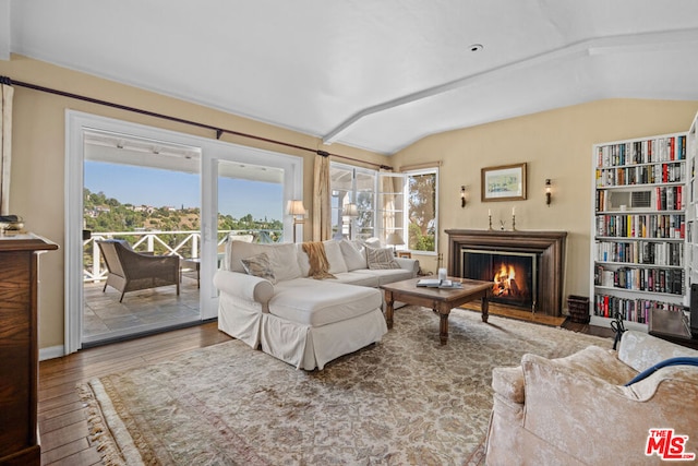 living room with hardwood / wood-style flooring and vaulted ceiling