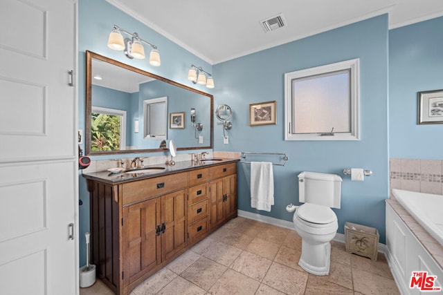 bathroom with vanity, crown molding, a tub, and toilet