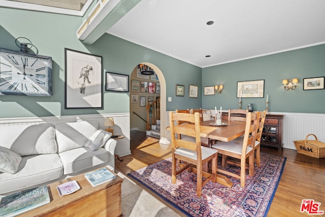 dining space featuring crown molding and hardwood / wood-style flooring