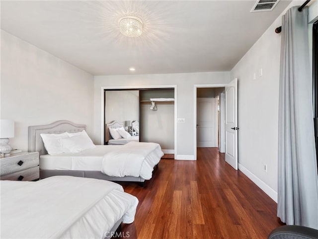 bedroom featuring dark hardwood / wood-style flooring and a closet