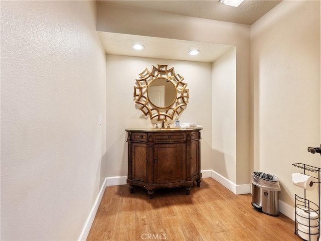 corridor with light hardwood / wood-style floors