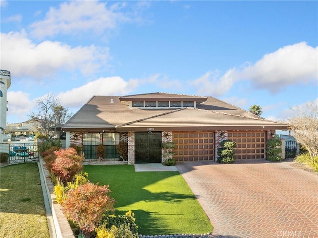 view of front of home featuring a garage and a front lawn