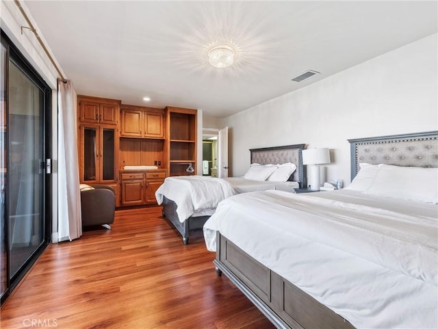 bedroom with dark hardwood / wood-style flooring