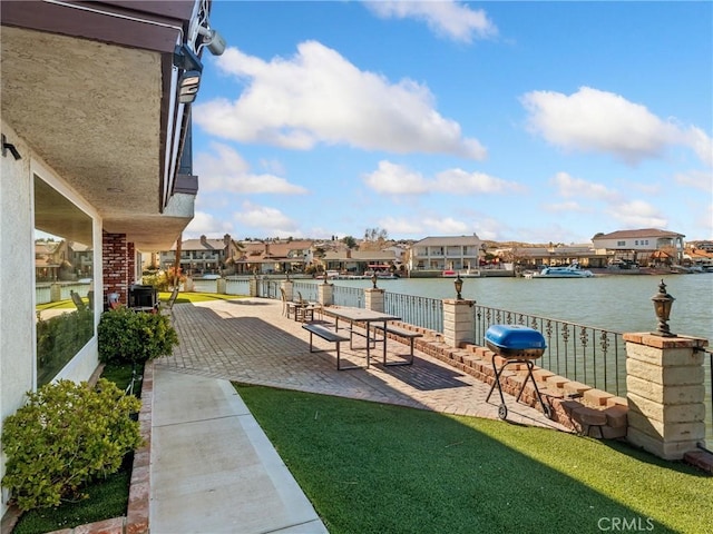 view of yard with a water view and a patio area