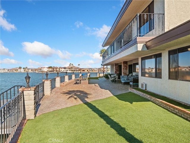 view of yard featuring a patio area and a water view