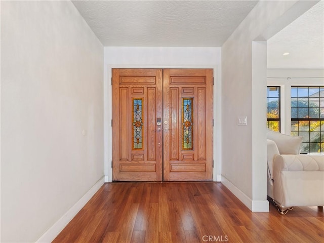 entrance foyer featuring dark hardwood / wood-style floors and a textured ceiling