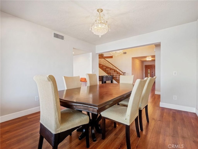 dining room featuring an inviting chandelier and dark wood-type flooring