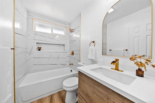 full bathroom with vanity, hardwood / wood-style floors, tiled shower / bath combo, and toilet