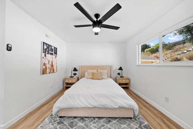 bedroom with ceiling fan and light wood-type flooring