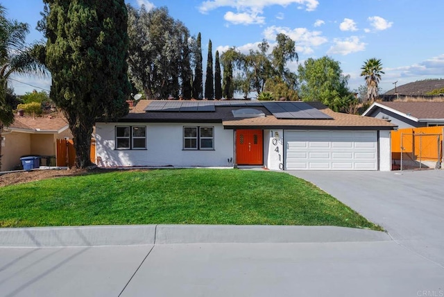 ranch-style house with a garage and a front lawn