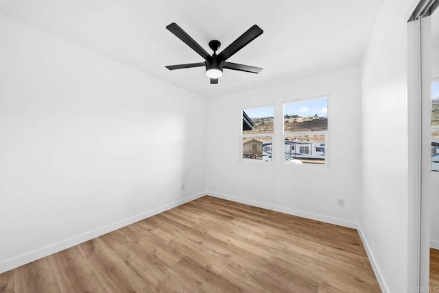 empty room with light hardwood / wood-style flooring and ceiling fan