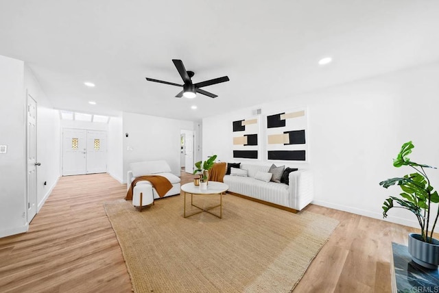 living room featuring ceiling fan and light hardwood / wood-style flooring