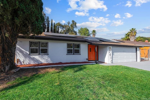 single story home featuring a garage, a front lawn, and solar panels