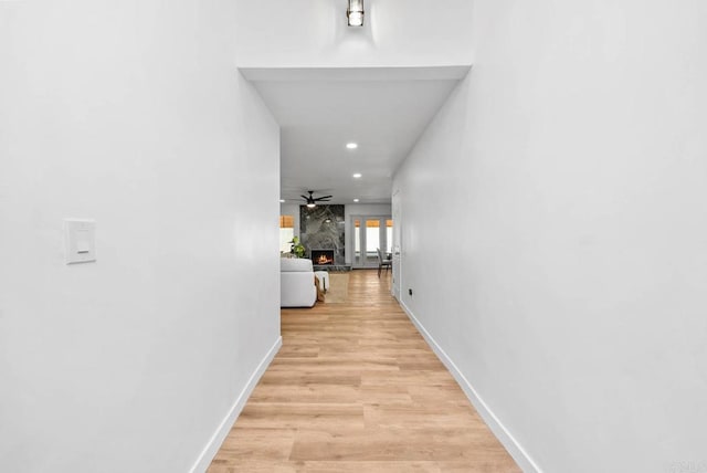 corridor with light hardwood / wood-style flooring