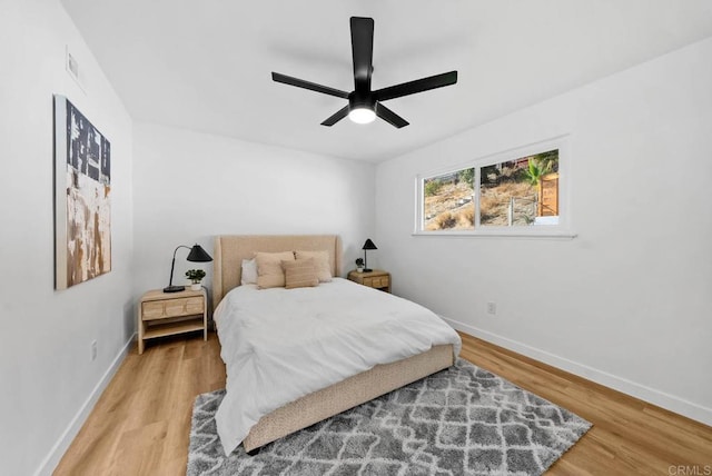 bedroom featuring hardwood / wood-style flooring and ceiling fan