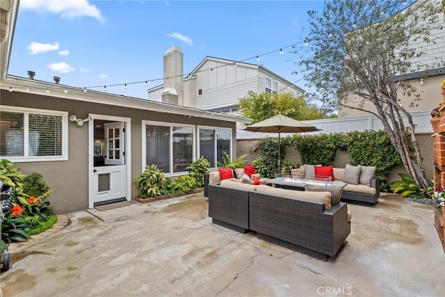 view of patio featuring outdoor lounge area and fence