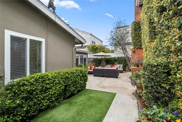 view of yard with a patio area, fence, and an outdoor hangout area